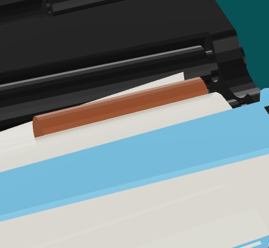 The corner of the paper under the tip, top view